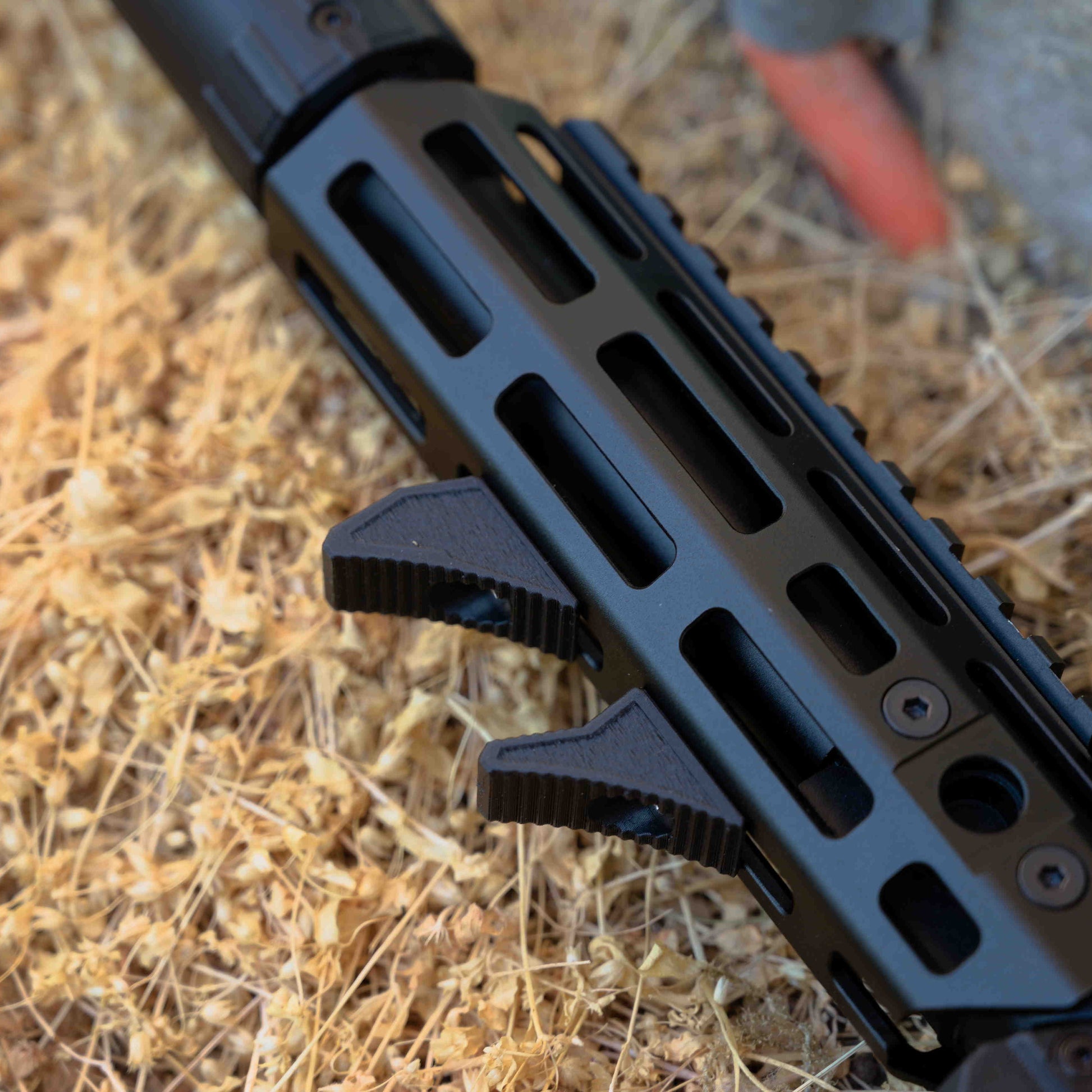 Close-up of a rifle barrel on a dry grass background